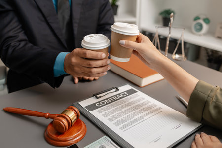 A lawyer and a client celebrate the successful completion of a legal agreement with a coffee toast...