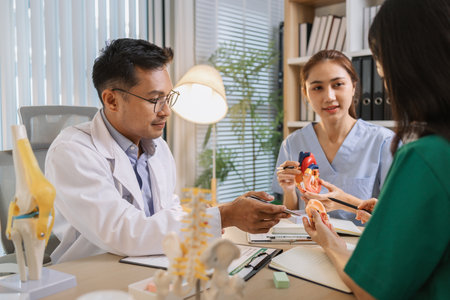 Medical professionals collaborating during a meeting to discuss patient care plans and treatment strategies. Doctors and nurses share expertise and analyze clinical data for better healthcare outcomesの写真素材