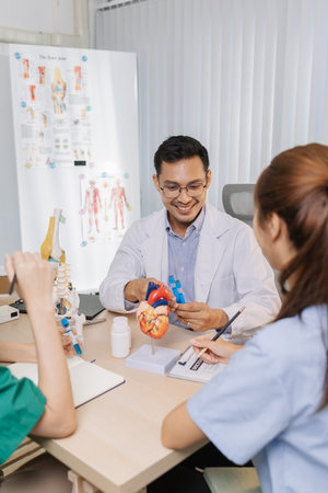 Group of doctors and nurses consulting about a complex patient case in hospital office. Team analyzing medical data and discussing diagnostic plans for accurate and efficient treatment.の写真素材
