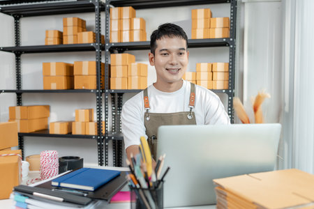 Entrepreneur in ecommerce startup preparing goods for online selling, reflecting small business operations, packaging, digital retail innovation, and modern global trade solutions.の写真素材