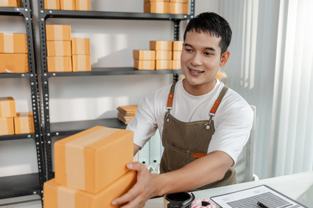 Ecommerce startup with young business owner, managing packages and sales, highlighting teamwork, logistics, online marketplace, and the role of technology in modern retail.の写真素材