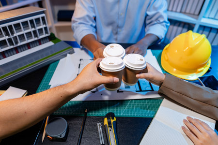 Engineers and architects analyze construction models and discuss project strategies, combining technical knowledge and creative ideas to achieve successful architectural design solutions.の写真素材