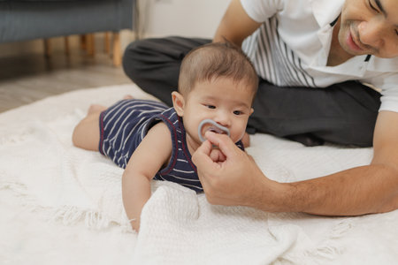 A father spends quality time with his baby, playing and bonding through gentle care and fun moments...