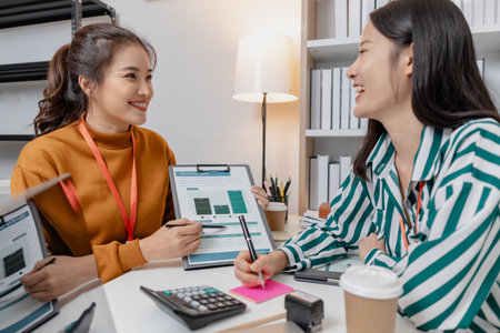 A group of professionals engaged in a collaborative business meeting, exchanging innovative ideas and strategies to build growth and success in a modern startup environment.の写真素材