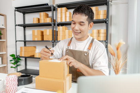 Young entrepreneur managing online business, preparing packages and working with e commerce...
