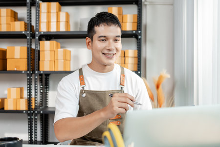 Ecommerce startup with young business owner, managing packages and sales, highlighting teamwork, logistics, online marketplace, and the role of technology in modern retail.の写真素材