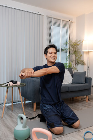 A young man exercising at home in a cozy living room, focusing on his health and fitness. He enjoys...