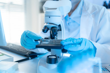 A chemistry researcher in a laboratory surrounded by scientific equipment and test tubes,...