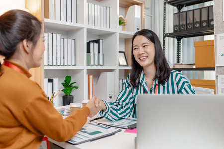 Colleagues collaborate in a business meeting, emphasizing teamwork, creativity, and strategic thinking to achieve shared goals, strengthen partnerships, and build sustainable growth in a startup.の写真素材