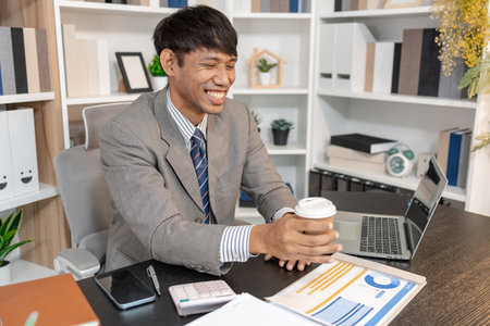 Businessman working at his desk in professional office environment, focusing on decision making, financial planning, and daily responsibilities that reflect modern corporate work and management tasks.の写真素材