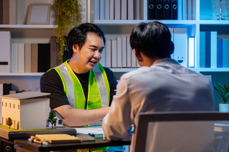 A team of architects and engineers coordinates on an architectural project, reviewing design concepts and technical plans to ensure efficiency and creativity in modern construction development.の写真素材
