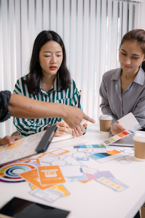 UX/UI designers presenting their final design project to the team, showcasing interface screens and...