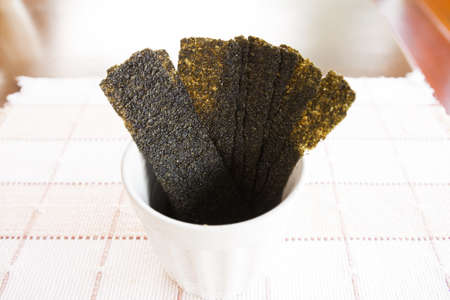 dry seaweed are sort in white cup  first courseの写真素材