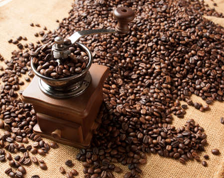 coffee grinder and beans background on sackの写真素材