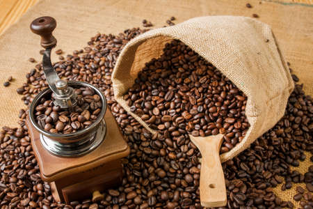 coffee grinder and beans background on sack and coffee sackの写真素材