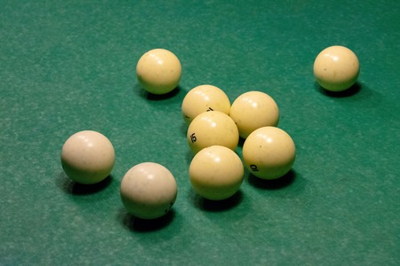 Ivory white billiard balls on a green pool table.の写真素材