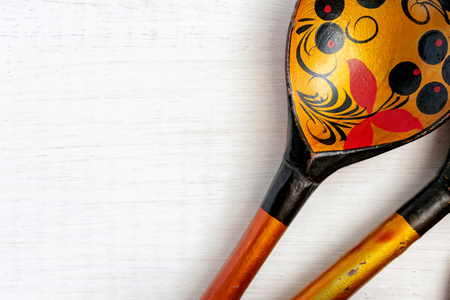 Russian wooden spoon on white background. National musical instrument. Painted in the traditional Khokhloma style. There's room for your text.の写真素材