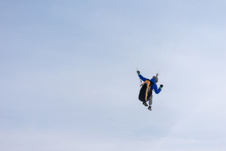 Togliatti, Russia - 10 march 2019. Paragliding on the background of blue sky. Paraglider holding the slings. Close-up photo.のeditorial素材