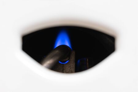 Nozzle and fire gas boiler close-up. white background. The boiler is in standby mode. the concept of...