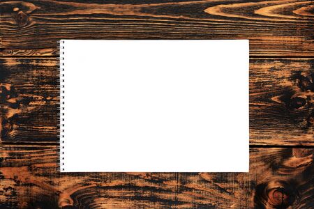Blank paper on the wooden background, top view, space for text or message. Blank paper mock-up.の写真素材