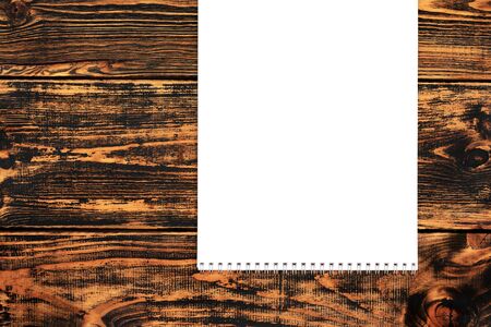 Blank paper on the wooden background, top view, space for text or message. Blank paper mock-up.の写真素材