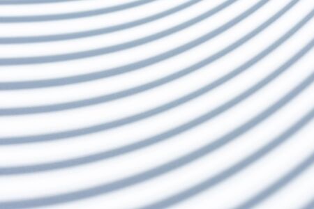 abstract striped paper white background. the paper is illuminated through the half-open blinds....