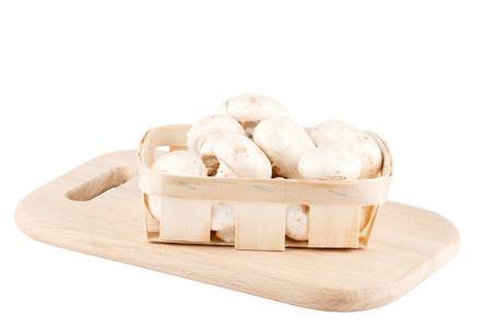Fresh mushrooms in a wooden box on the white backgroundの写真素材