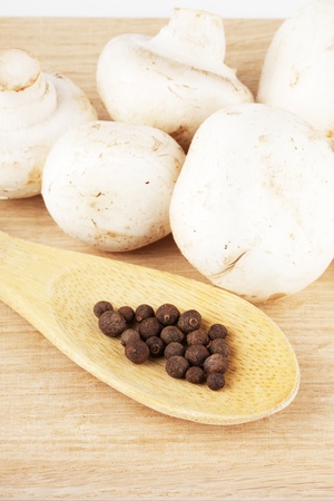 Fresh mushrooms with spoon of pepperの写真素材