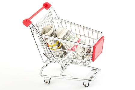 Shopping cart and dollars on the whiteの写真素材