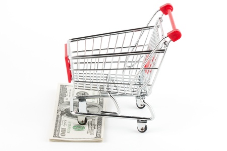 Shopping cart and dollars on the whiteの写真素材