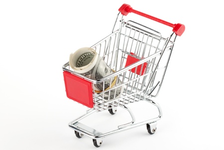 Shopping cart and dollars on the whiteの写真素材