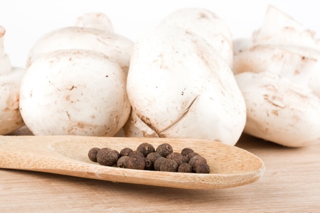 Fresh mushrooms with spoon of pepperの写真素材