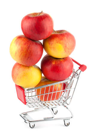 Buying healthy food. Shopping trolley with apples on whiteの写真素材