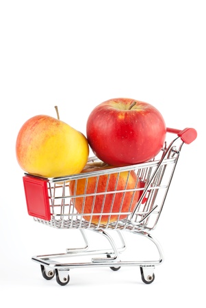 Buying healthy food. Shopping trolley with apples on whiteの写真素材