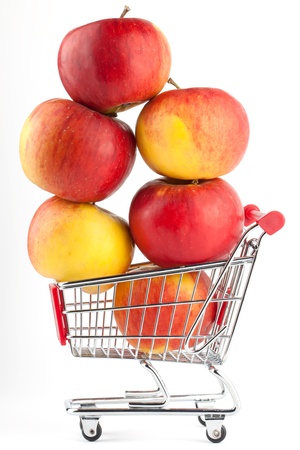 Buying healthy food. Shopping trolley with apples on whiteの写真素材