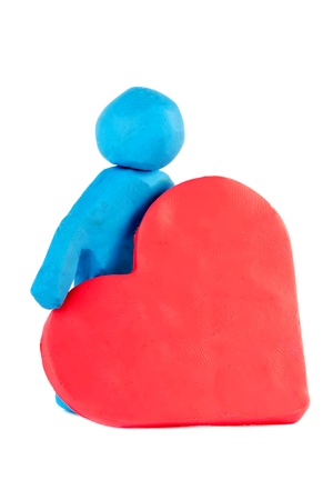 Plasticine man with plasticine heart on the white backgroundの写真素材