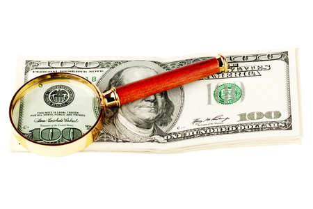 Hundred dollar bill under a magnifying glass  on the whiteの写真素材