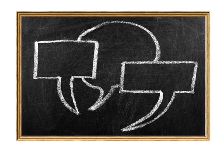 Speech bubbles drawn with chalk on blackboard with wooden frameの写真素材