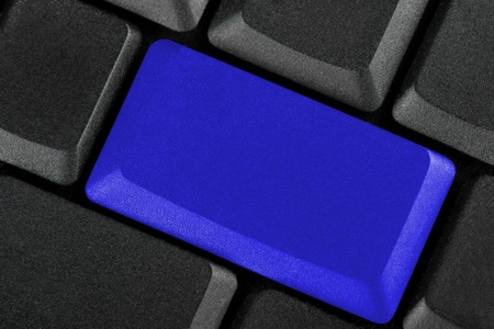 Black keyboard with blank blue buttonの写真素材