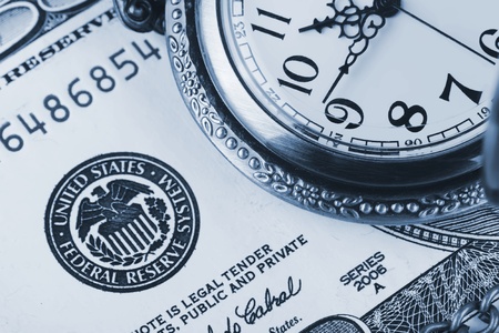 Time and money concept image. Pocket watch and US currencyの写真素材