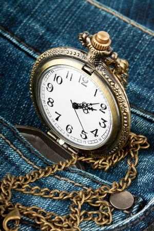 Closeup pocket watch in pocket of jeansの写真素材