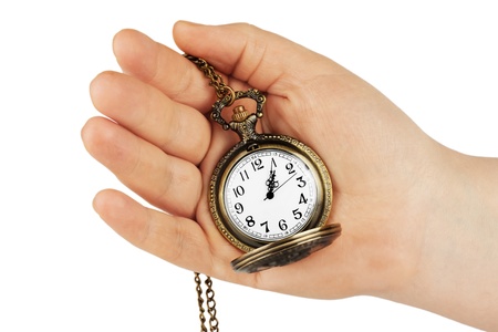 Golden pocket watch in hand on the white backgroundの写真素材