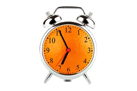 Time to bring back health. Fresh orange fruit alarm clock on the white backgroundの写真素材