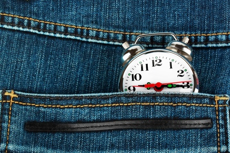 Closeup pocket watch in pocket of jeansの写真素材