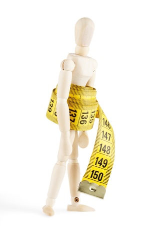 Weight loss Success Concept  Dummy with measuring tape on the white backgroundの写真素材