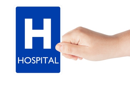 Hospital traffic sign in the hand on the white backgroundの写真素材