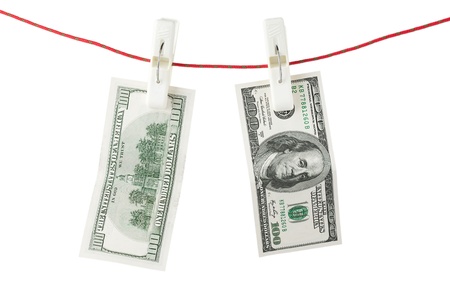 One hundred bills with clothespins on a white background.