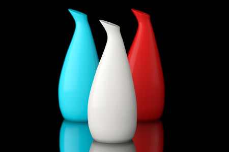 Three color ceramic vases on a black backgroundの写真素材