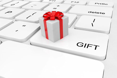 Gift concept. Extreme closeup gift box on a keyboardの写真素材