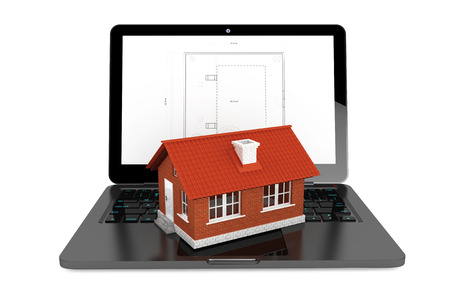 3d House over Laptop with House Project Blueprint on a white backgroundの写真素材